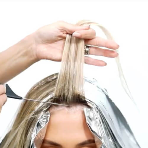 Womens hair being colored at the roots