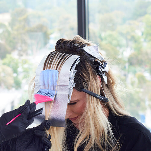 Stylist Larisa Love prepping clients hair for color