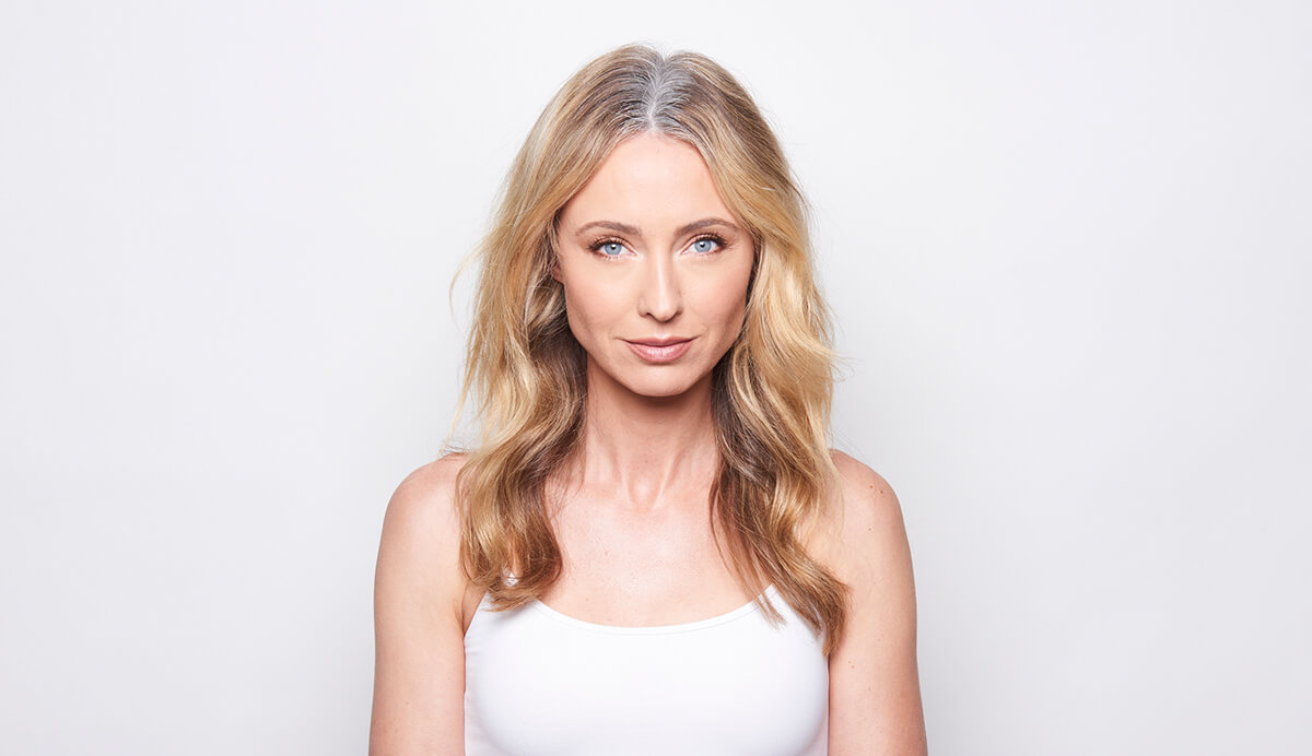 Model before hair coloring with gray roots