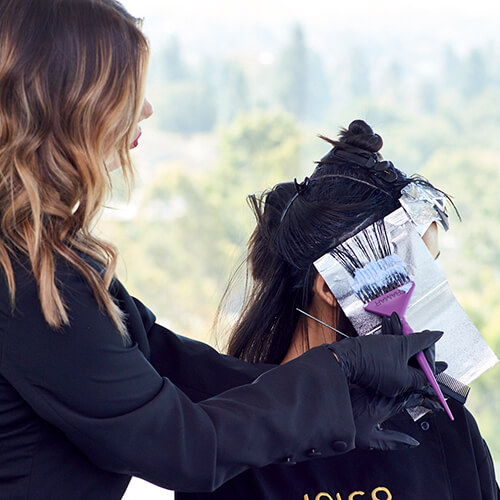 Client getting hair colored with foils