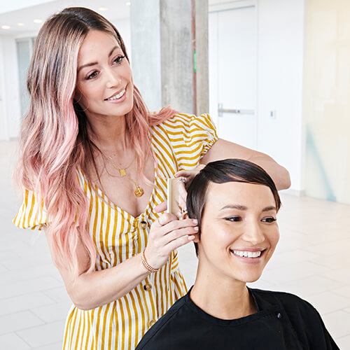 Hairstylist Jill Buck coloring clients hair