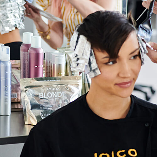 Hairstylist Jill Buck coloring clients hair