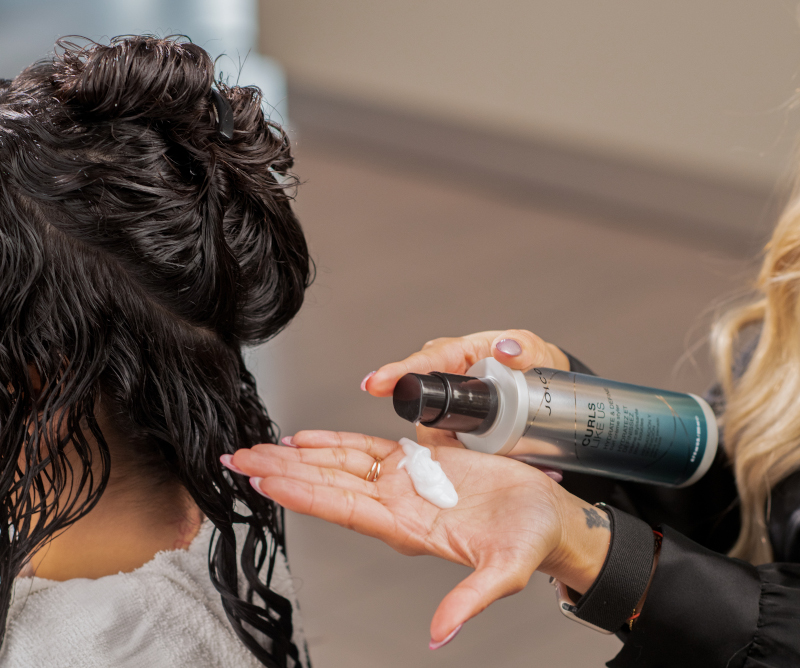 stylist applying product to hair