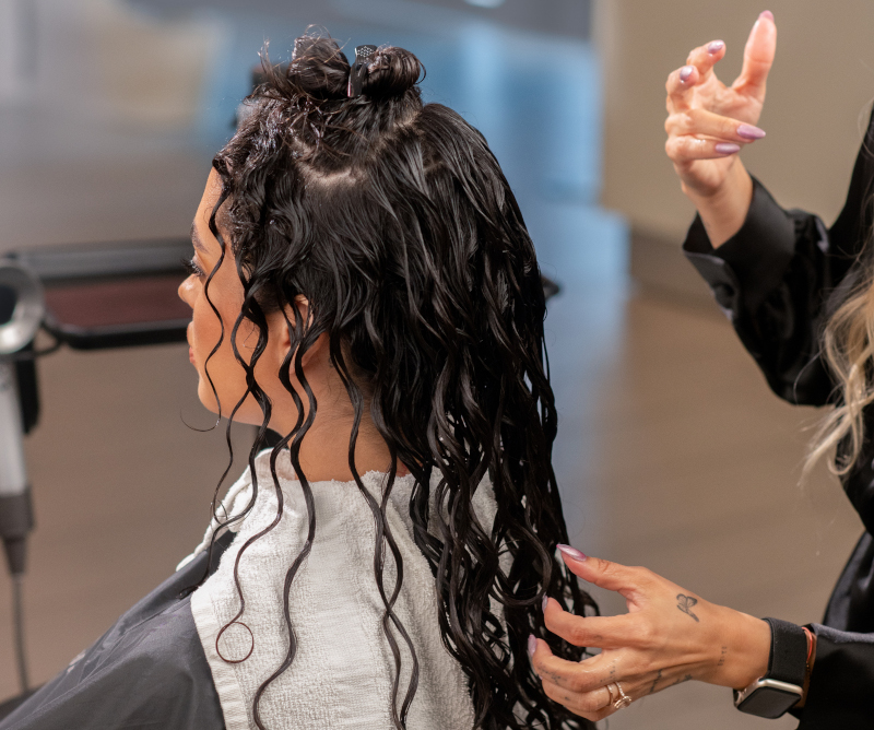 stylist treating hair model