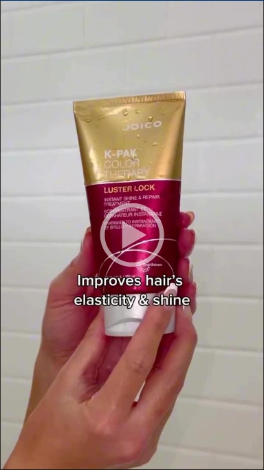 Woman holding K-Pak Color Therapy luster lock treatment bottle