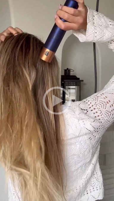 Woman blow drying hair hair